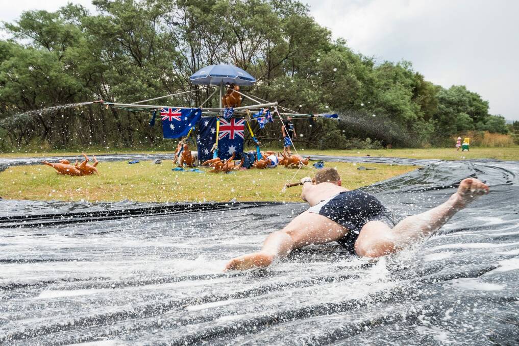 Hills Hoist Slide at Pine Island on Australia Day. Kaleb Dalla Costa tries to hold on as he spins around the slide.  Photo: Dion Georgopoulos