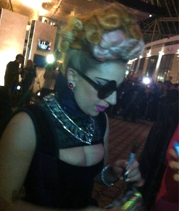 Lady Gaga signs autographs for fans in Perth. Photo via Twitter: @erhamonster