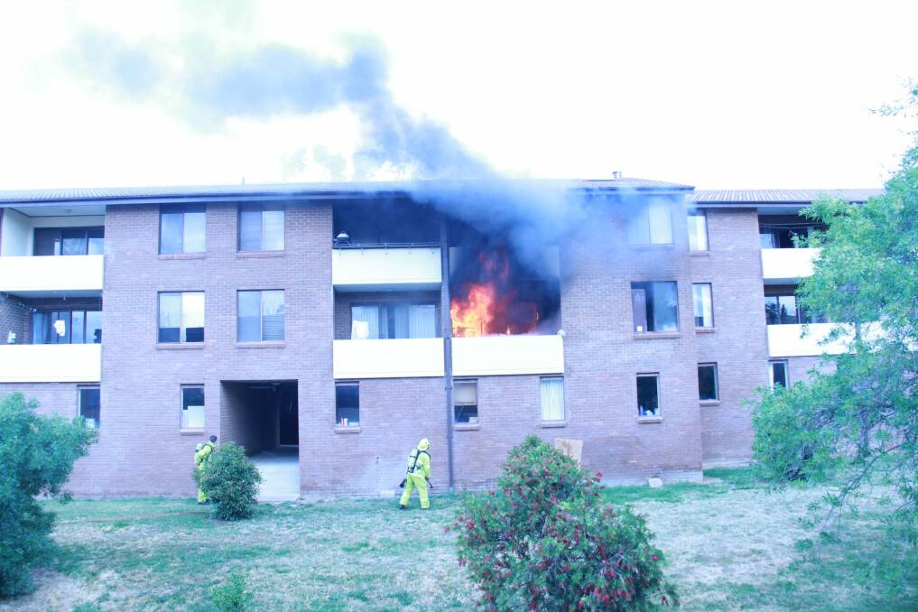 Fire completely destroyed an apartment in Hawker. A cat can be seen escaping by jumping from the balcony. Photo: Steven Tritton