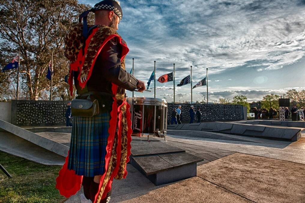 One of the drummers from the  Australian Federal Police Pipes and Drums wearing the Canberra tartan. Photo: Greg Primmer