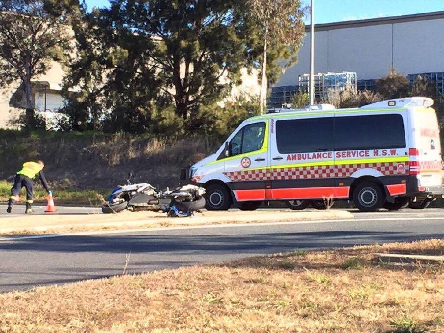 Two ambulances were on the scene of a crash between a truck and a motorcycle in Queanbeyan. Photo: Andrew Brown