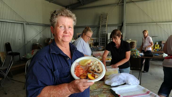 Gail Butt, of Young, helps locals co-ordinate the food and beverage supplies for the fire crews battling blazes near Bookham on the Southern Tablelands. Photo: Graham Tidy