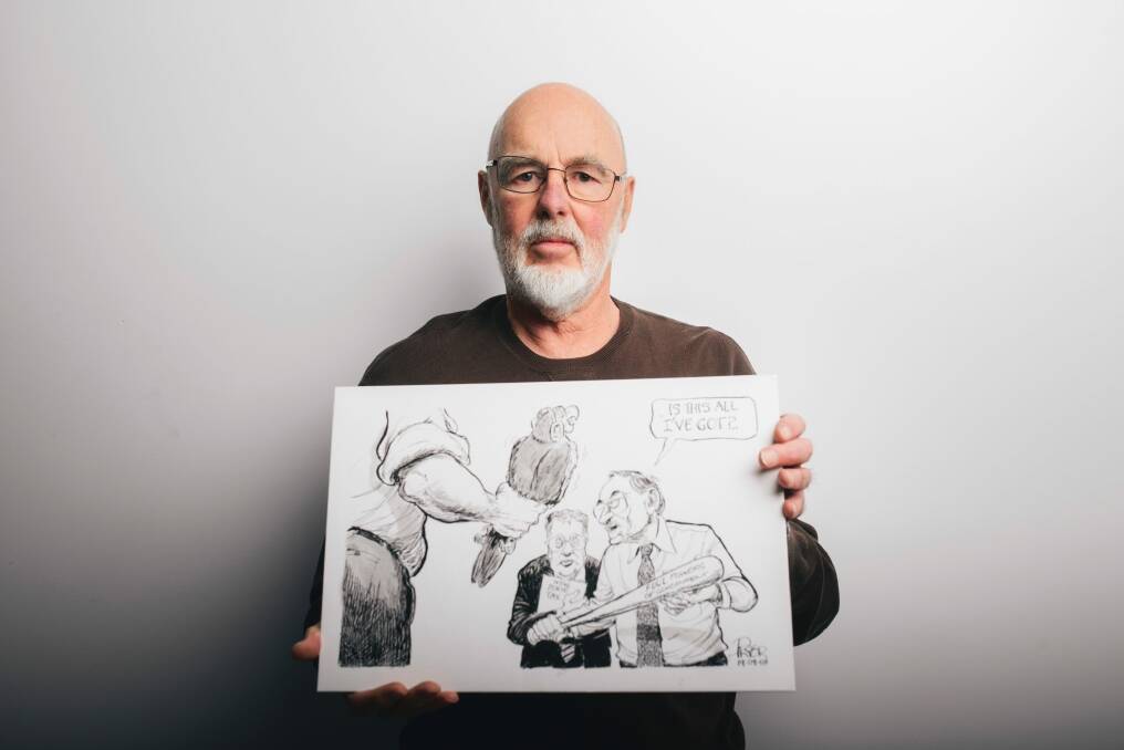 Former cartoonist for The Canberra Times, Geoff Pryor, with one of the cartoons now stored at the National Library of Australia, where he has just finished cataloging the work. Photo: Rohan Thomson