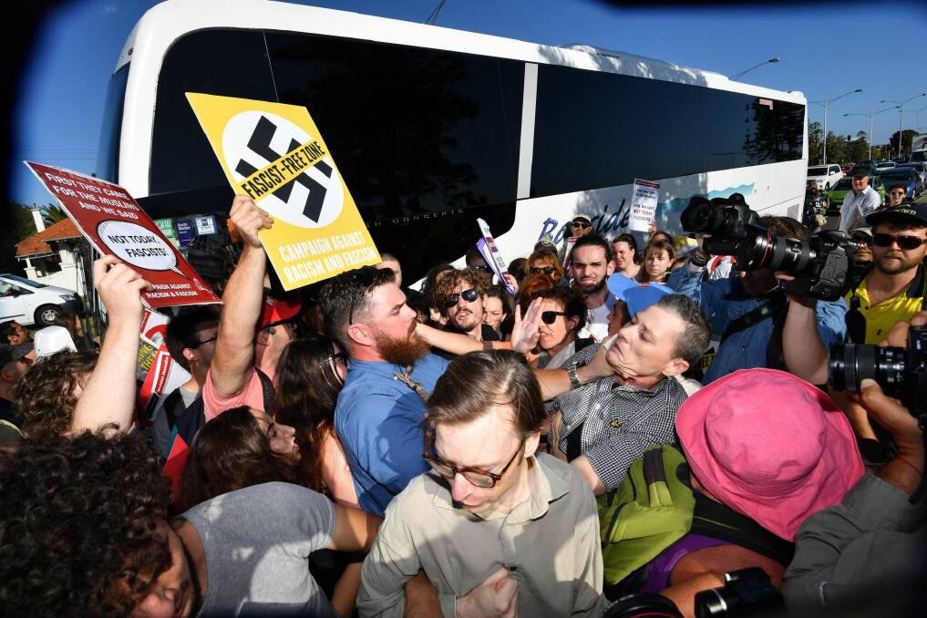Anti-racist activists stop Q Society members boarding a bus at St Kilda Marina. Photo: Joe Armao