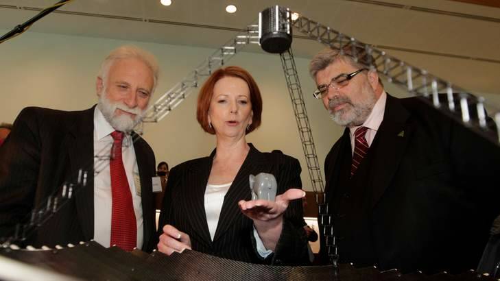 Former prime minister Julia Gillard with Tony Robey (left) of Wizard Power and then Innovation Minister Kim Carr at a clean technology exhibition in 2011. Photo: Unknown via Aperture