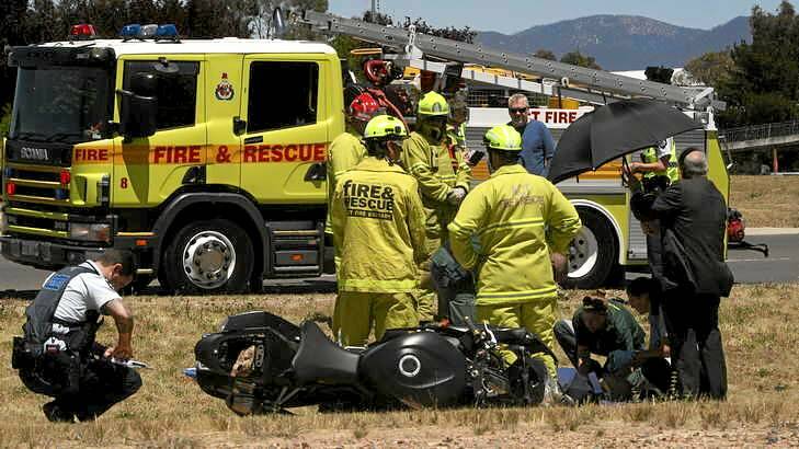 A motorcyclist is treated at the scene of an accident on Isabella Drive at Tuggeranong. Photo: Grant Newton
