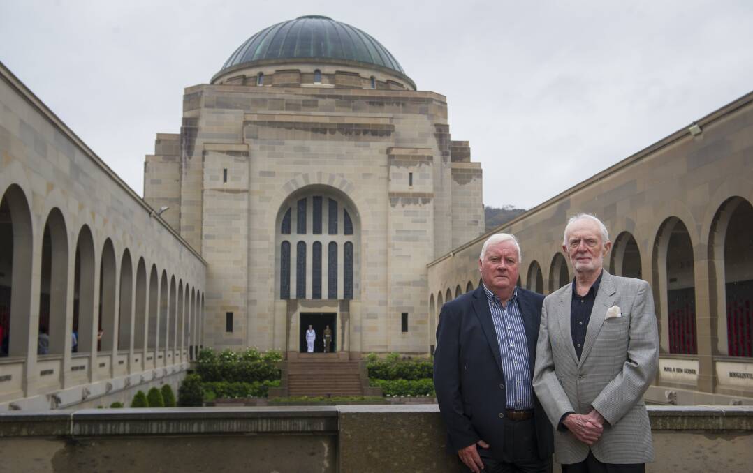 Former deputy director of the Australian War Memorial, Michael McKernan with former director of the Australian War Memorial, Brendon Kelson, 25 years since the Unknown Solider was interred in the Hall of Memory behind them.  Photo: Elesa Kurtz