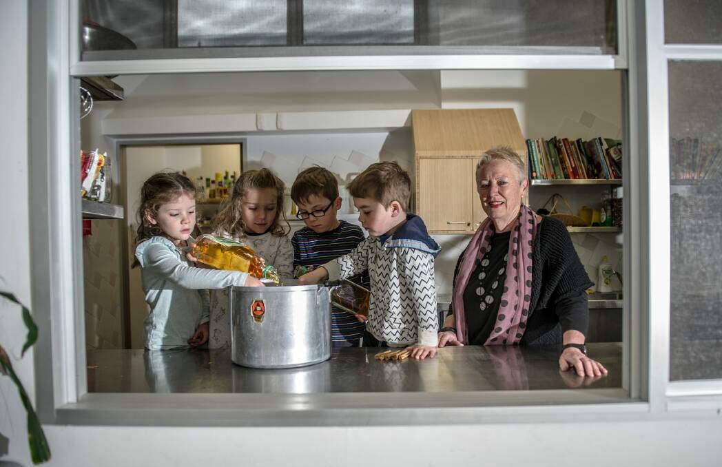 Blue Gum Community School executive director Maureen Hartung questions recent education funding changes. Pictured with (from left) Lucy Brown, Ivy Marriott, Max Morley and Nadav Aviram doing a cookery class. Photo: Karleen Minney