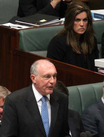 Debate stuck on repeat in leaders' absence: Acting Prime Minister Warren Truss watched by Peta Credlin during question time. Photo: Alex Ellinghausen