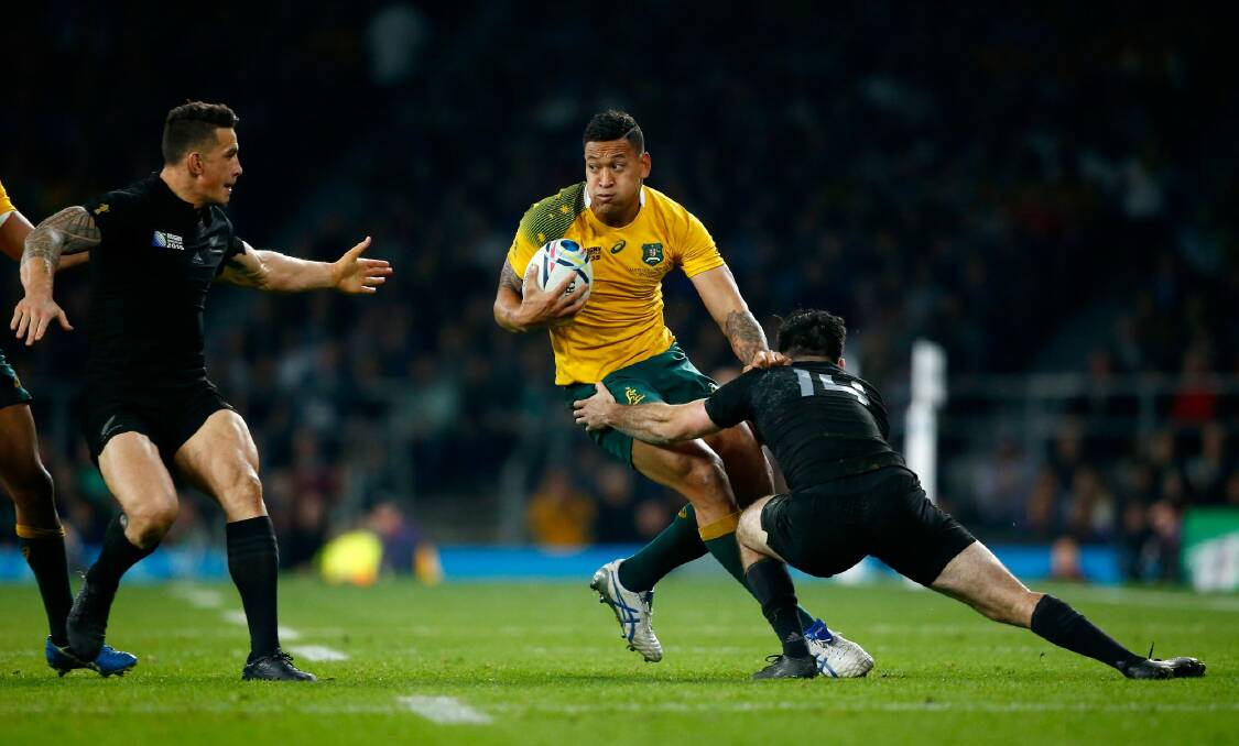 On the move: Israel Folau runs into the All Blacks defence in the World Cup final. Photo: Stu Forster