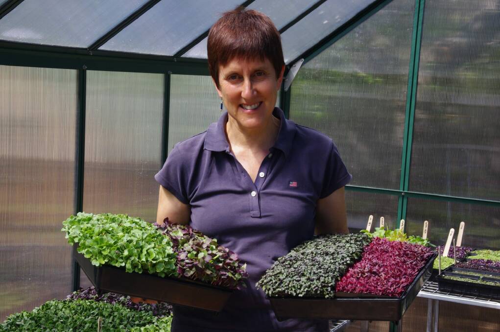 Fiona Buining with homegrown microgreens.