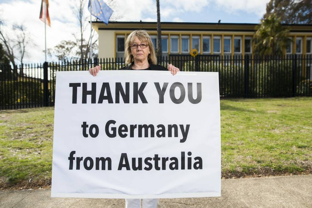 Lynn Russell of Yarralumla outside the German Embassy with a sign thanking Germany for their leadership in the refugee crisis in Europe. Photo: Rohan Thomson
