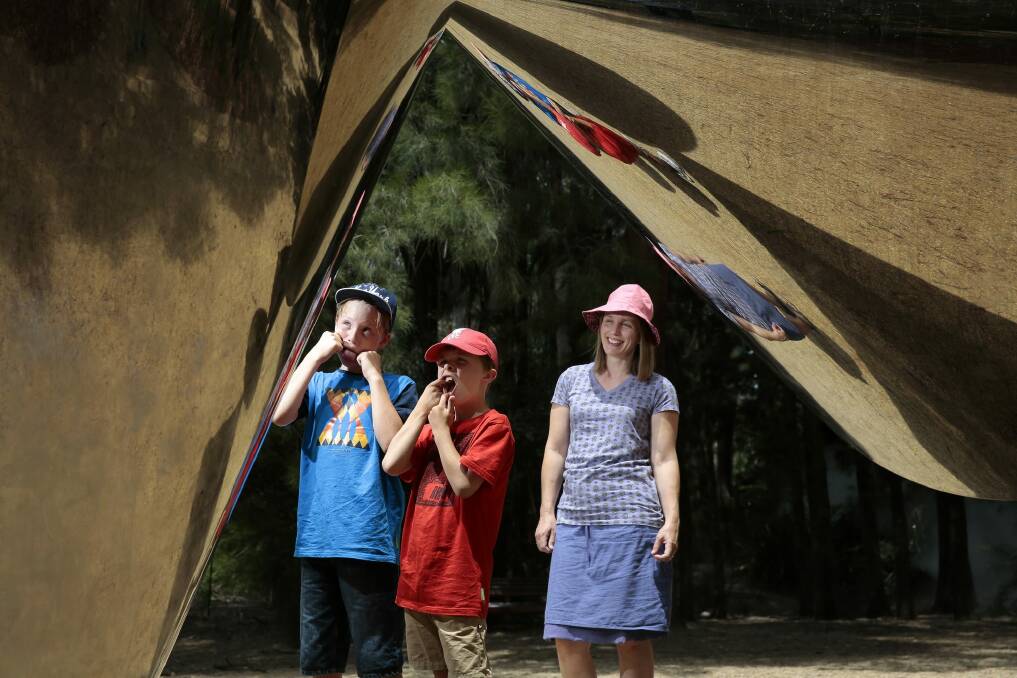 From left, brothers Ben Davies, 11, and James Davies, 8, of Melbourne with mum Melanie Davies, clowning around with their reflections in the sculpture cones by Bert Flugelman  at the National Gallery of Australia. Photo: Jeffrey Chan