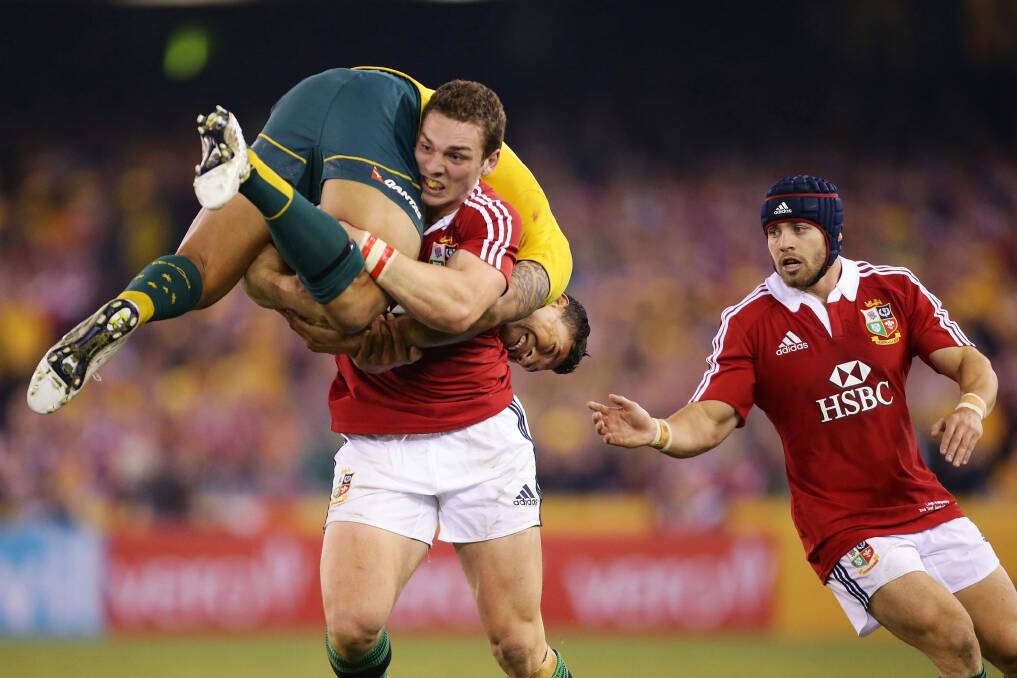 Carry on: George North lifts Israel Folau during the Australia v Lions Test last year. Photo: Getty Images