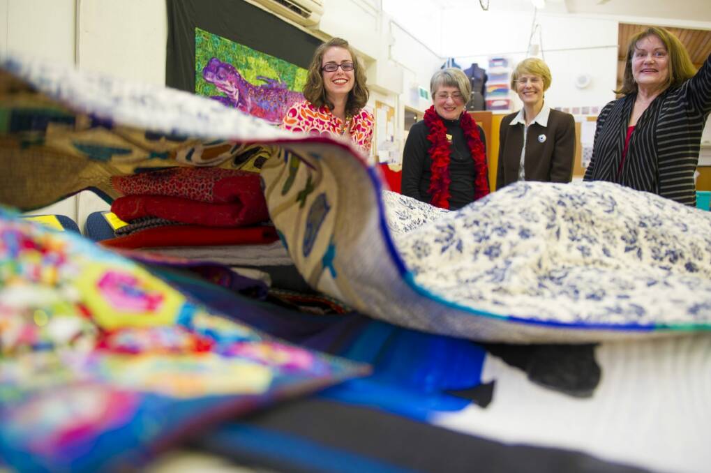 Canberra Quilters member Gemma Jackson, president Helen Rose, Jan Gorgon and Karen Brown with quilts to be shown at the show. Photo:  Jay Cronan