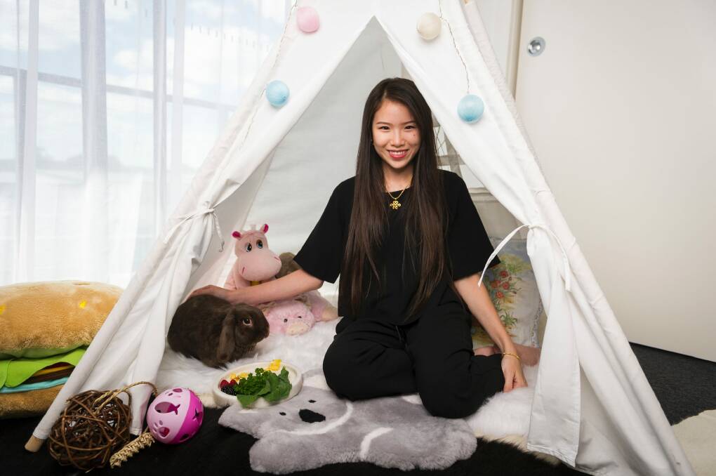 Cocobunbuns in his teepee with owner Sarah Pineda. Photo: Dion Georgopoulos