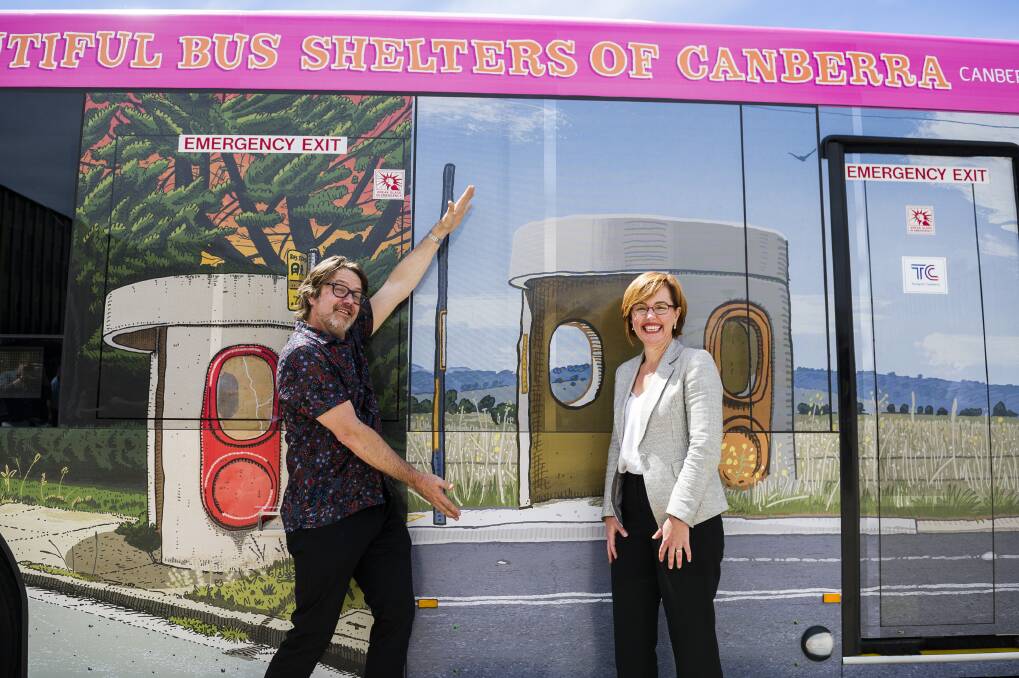 Canberra artist Trevor Dickinson and Transport Minister Meegan Fitzharris in front of a bus wrapped in his iconic bus stop artworks. Photo: Dion Georgopoulos