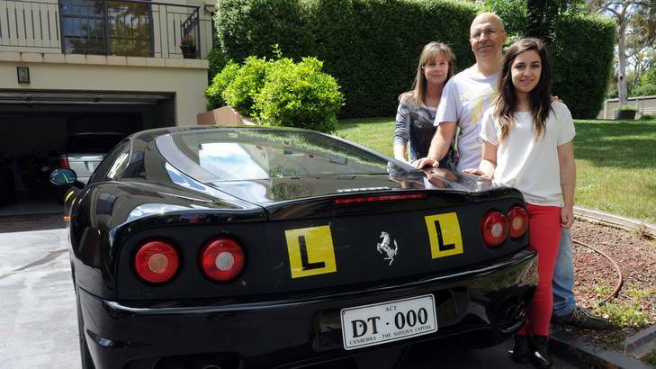 Dennis Toulis of Narrabundah with his wife Catherine Mann and daughter, Kathryn Toulis, 19, with the family's Ferrari 360 Modena. Photo: Graham Tidy