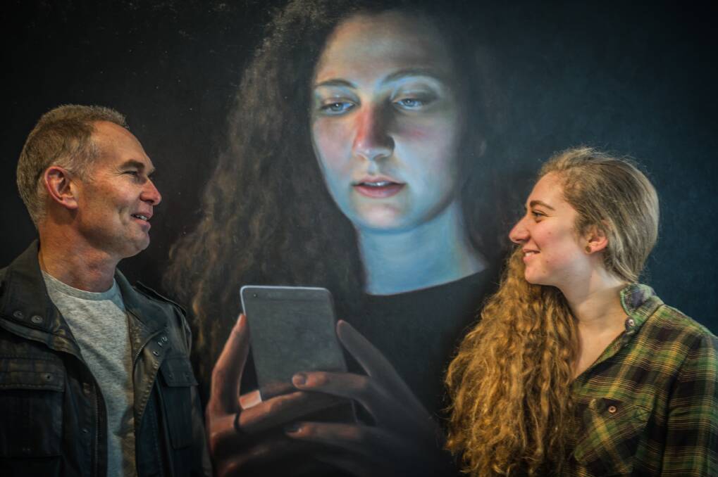Ross Townsend with his daughter Hannah and his portrait of her which was a finalist in the Douglas Moran National portrait prize in 2017. Photo: Karleen Minney