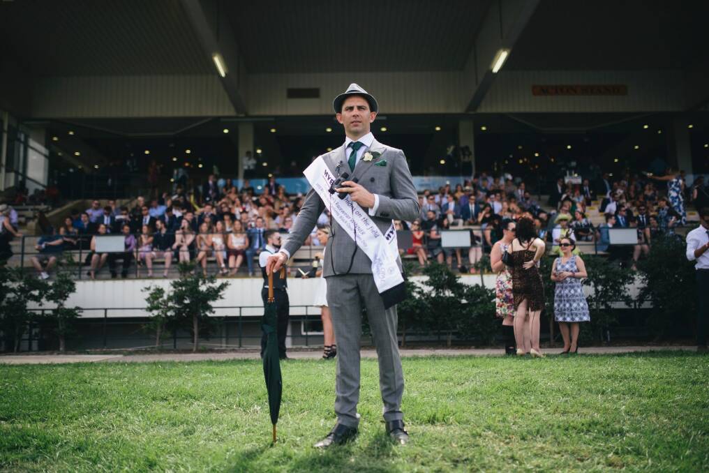 A classic grey suit with white shirt and green accessories made Hamish Lardi of Braddon the winner of Men's Fashions on the Field. Photo: Rohan Thomson