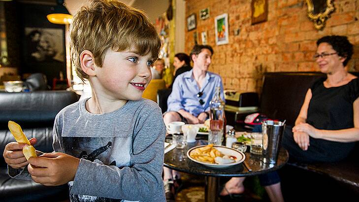 The Ryan family Dennis, Jane, and 4-year-old Hugo, from Braddon, enjoy lunch at the family friendly 'A Bite To Eat' cafe at Chifley Shops. Photo:  Rohan Thomson