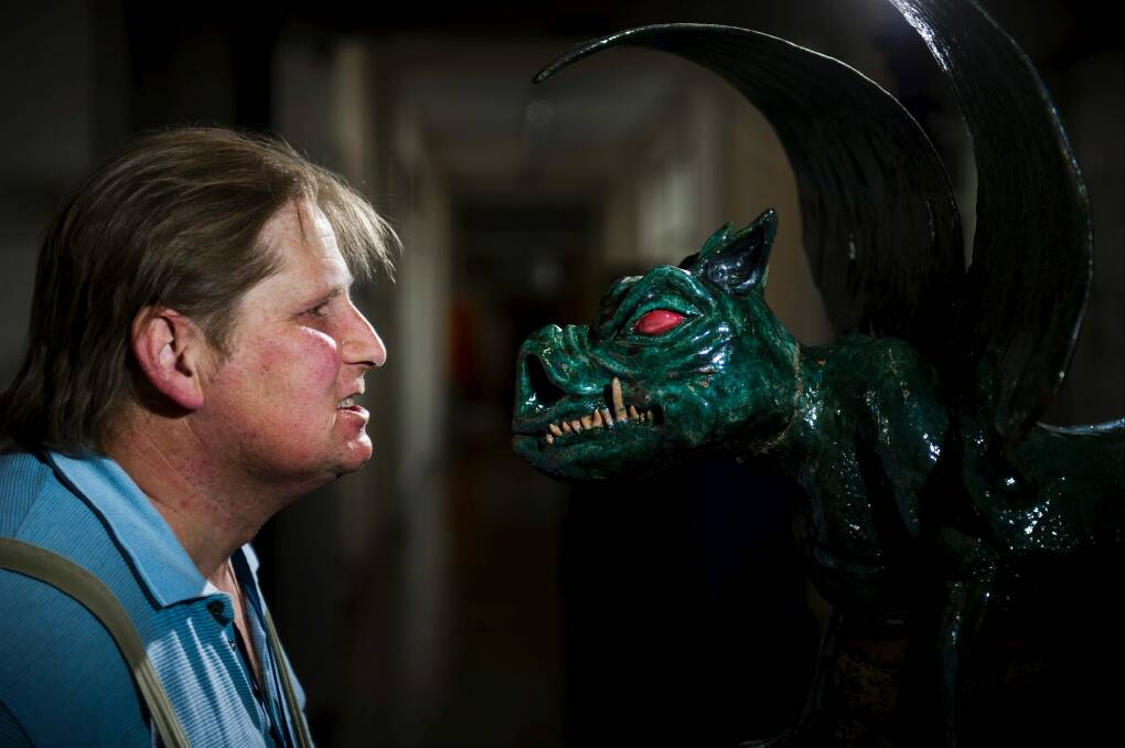 Franz Schroedl with his ceramic gargoyle in the entry at the ANU School of Art. Photo: Rohan Thomson
