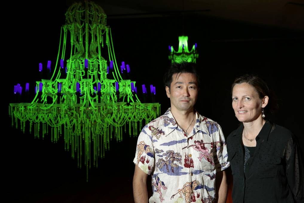  Artists Ken and Julia Yonetani stand in front of their work USA 2013 a chandelier made from uranium glass.  Photo: Jeffrey Chan