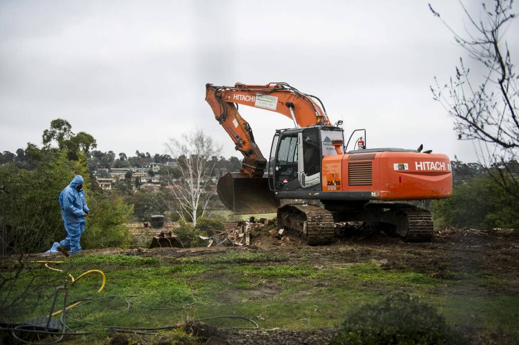 Say goodbye: Workers demolish a Mr Fluffy home in Woden on Tuesday morning. Photo: Rohan Thomson