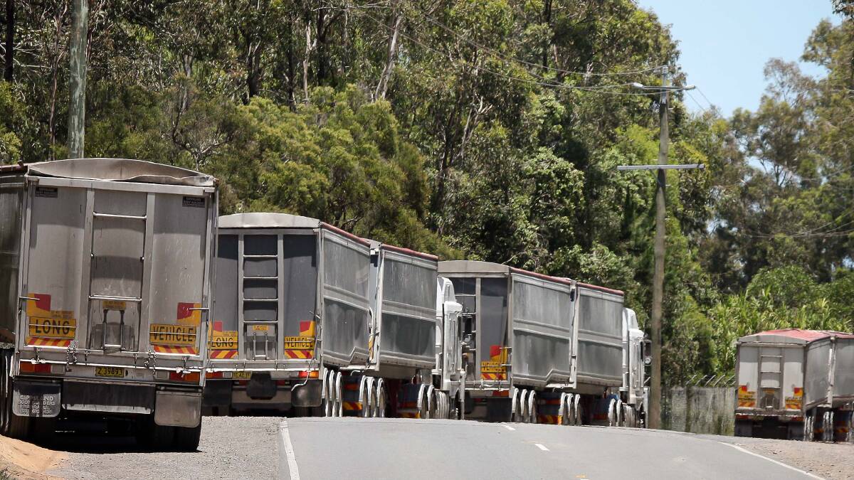 The queue: Trucks with NSW licence plates carrying construction waste line up outside Cleanaway's Willawong recycling facility on Brisbane's southside. Photo: Mark Solomons