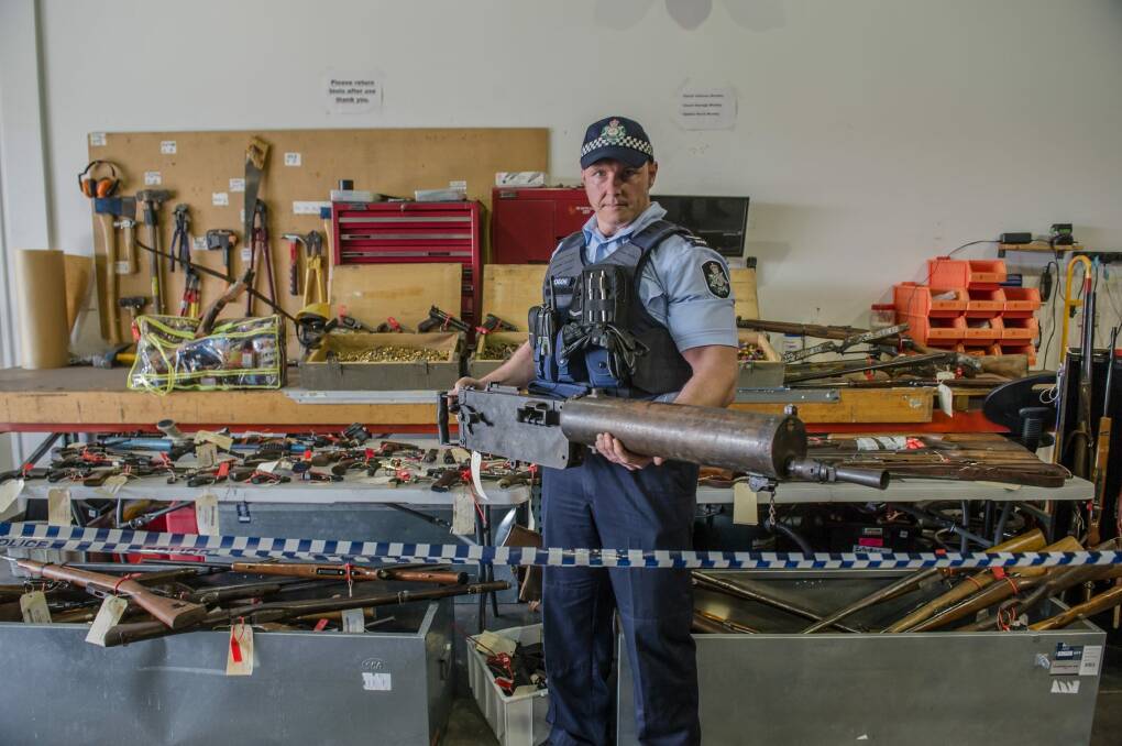 National Firearms Amnesty haul in the ACT. First constable Douglas Djurica with a WWI machine gun which will be donated to the Australian War Memorial.  Photo: karleen minney