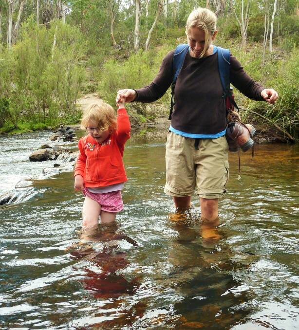 Mrs Yowie helps Emily across the river on the walk to the Big Hole. Photo: Tim the Yowie Man
