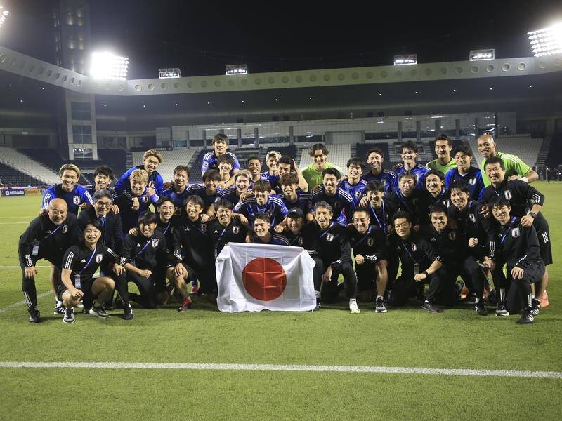 Japan's players pose for a photo after reaching the Olympics via the U23 Asian Cup semi-finals. (AP PHOTO)