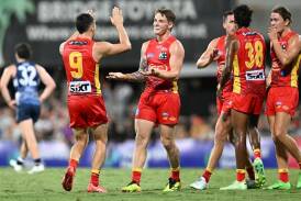 The Gold Coast Suns have thumped Geelong 164-100 to boost their hopes of playing finals football. (Darren England/AAP PHOTOS)