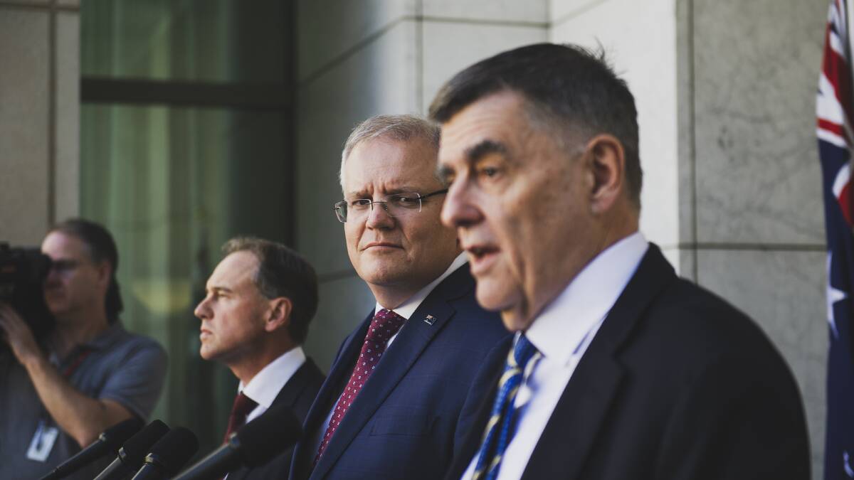 Scott Morrison watches as chief medical officer Brendan Murphy addresses the media. Picture: Dion Georgopoulos