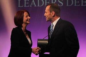 Head to head ... Julia Gillard and Tony Abbott shake hands before yesterday's debate in Canberra. Photo: Andrew Meares.