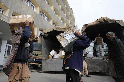 Kashmiri porters carry the official files of the Civil Secretariat of Jammu and Kashmir during the biannual Darbar Move of the state's capital.
