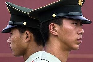 Paramilitary policemen stand guard near Tiananmen Square.