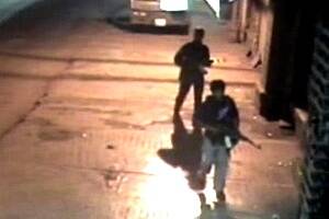 Closed circuit television footage shows gunmen walking across a parking lot after a shooting spree at the Chhatrapati Shivaji Terminus train station in Mumbai.
