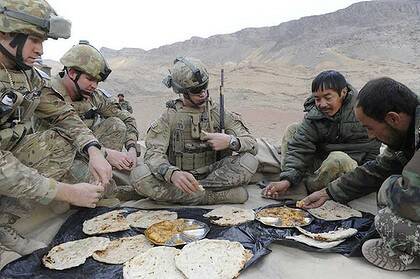 Australian soldiers at a breakfast meeting with Afghan army counterparts discuss a patrol in Oruzgan province.
