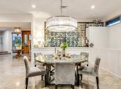 A Hughes home with a "wine library" in the dining room has set a suburb record. Picture supplied