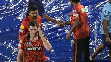 Pat Cummins walks off the rain-hit stadium at Hyderabad, knowing Sunrisers are in the playoffs. (AP PHOTO)