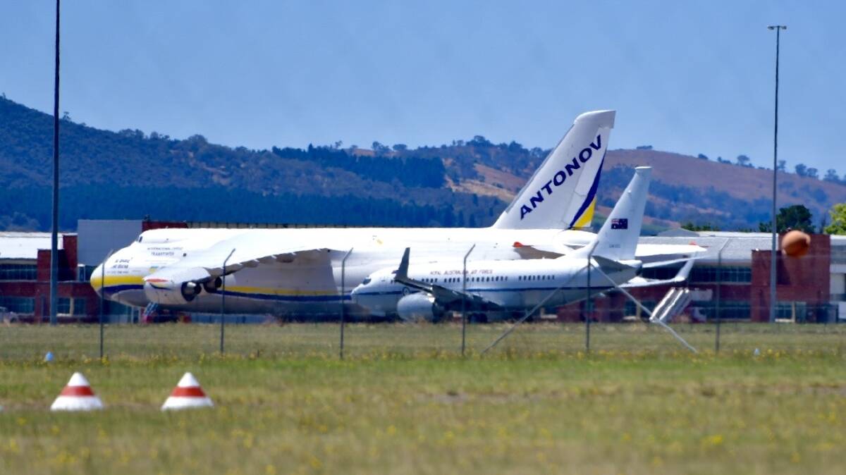 A Ukrainian Antonov 124-100 at Canberra Airport in Fairbairn where it dwarfs a nearby RAAF jet. Picture by Elesa Kurtz