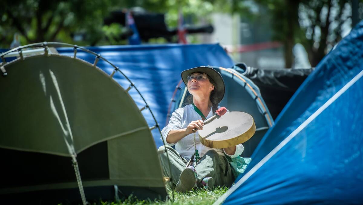 Elizabeth Steward of Mornington Peninsula in Victoria, plays her drum at the protest camp in EPIC to soothe peace to the crowds when they come home from a day of protesting. Picture: Karleen Minney