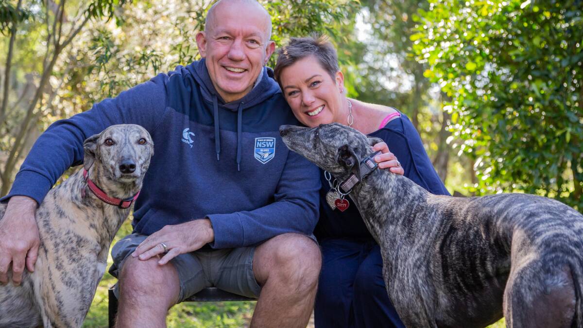 Author Kylie Miller with her partner, Brett, and their greyhounds, Teddy and Dotty at home in Gippsland. 