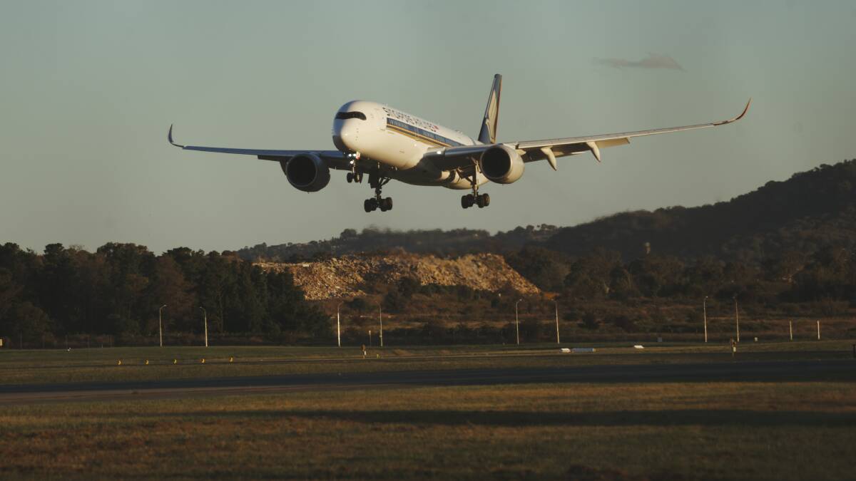 A repatriation flight from Singapore lands in Canberra Airport on Monday. Picture: Dion Georgopoulos
