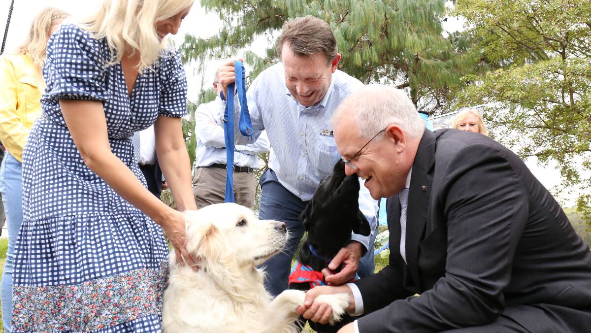 Prime Minister Scott Morrison shakes hands with Shannie. Picture: James Croucher