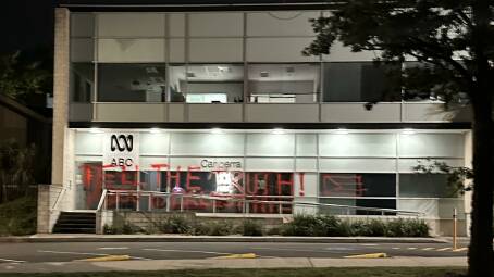 Gaza graffiti being sprayed onto the front entrance of the ABC. Picture supplied