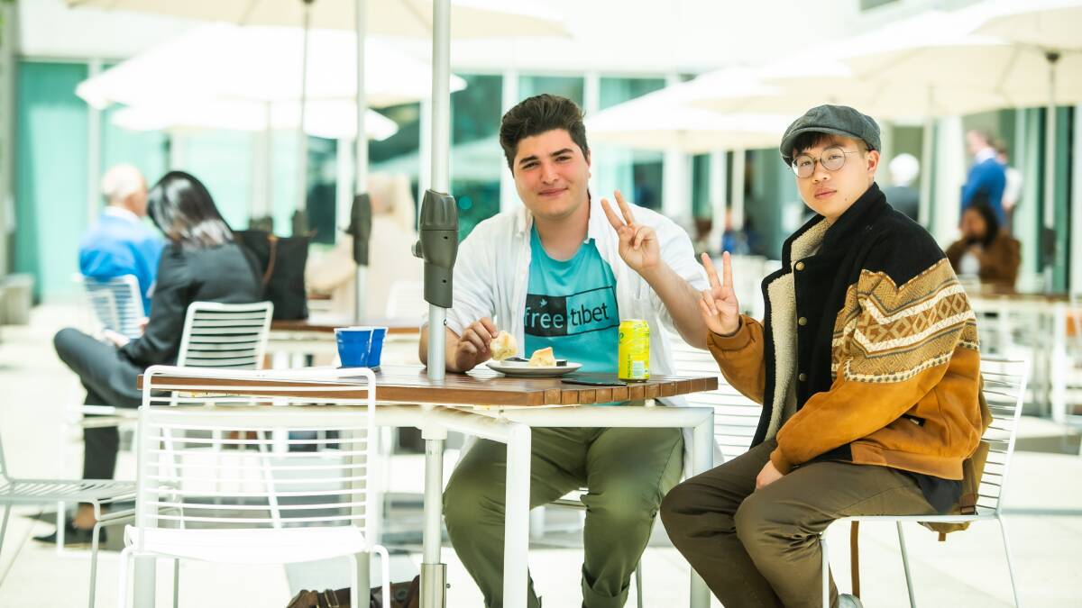 Drew Pavlou (left) and Max Mok share scones and cream at Parliament houses' Queens Terrace café a day after they were removed from Parliament House by AFP police officers as persons of high risk without explanation. Picture by Karleen Minney