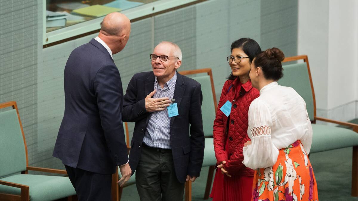 Opposition Leader Peter Dutton speaks to Professor Sean Turnell and his wife Ha Vu are during Question Time on Thursday. Picture by Sitthixay Ditthavong