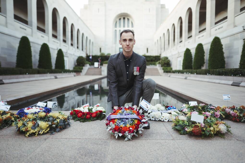 President of Defence LGBTI Information Service Nathan White at a Last Post Ceremony at the Australian War Memorial on Friday. Rainbow wreaths were laid to commemorate LGBTI veterans among the fallen. Picture: Dion Georgopoulos